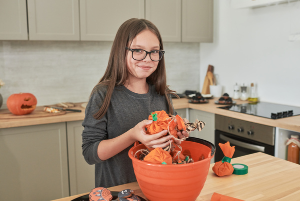 Girl Puts Sweet Halloween Bundles in Common Bowl